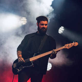 RW playing a bass guitar